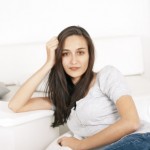 Beautiful Brunette Single Girl Sitting on White Couch White Tshirt