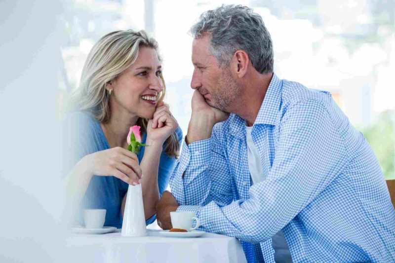 first date midlife couple after 40 smiling chemistry body language eye contact flirt chemistry